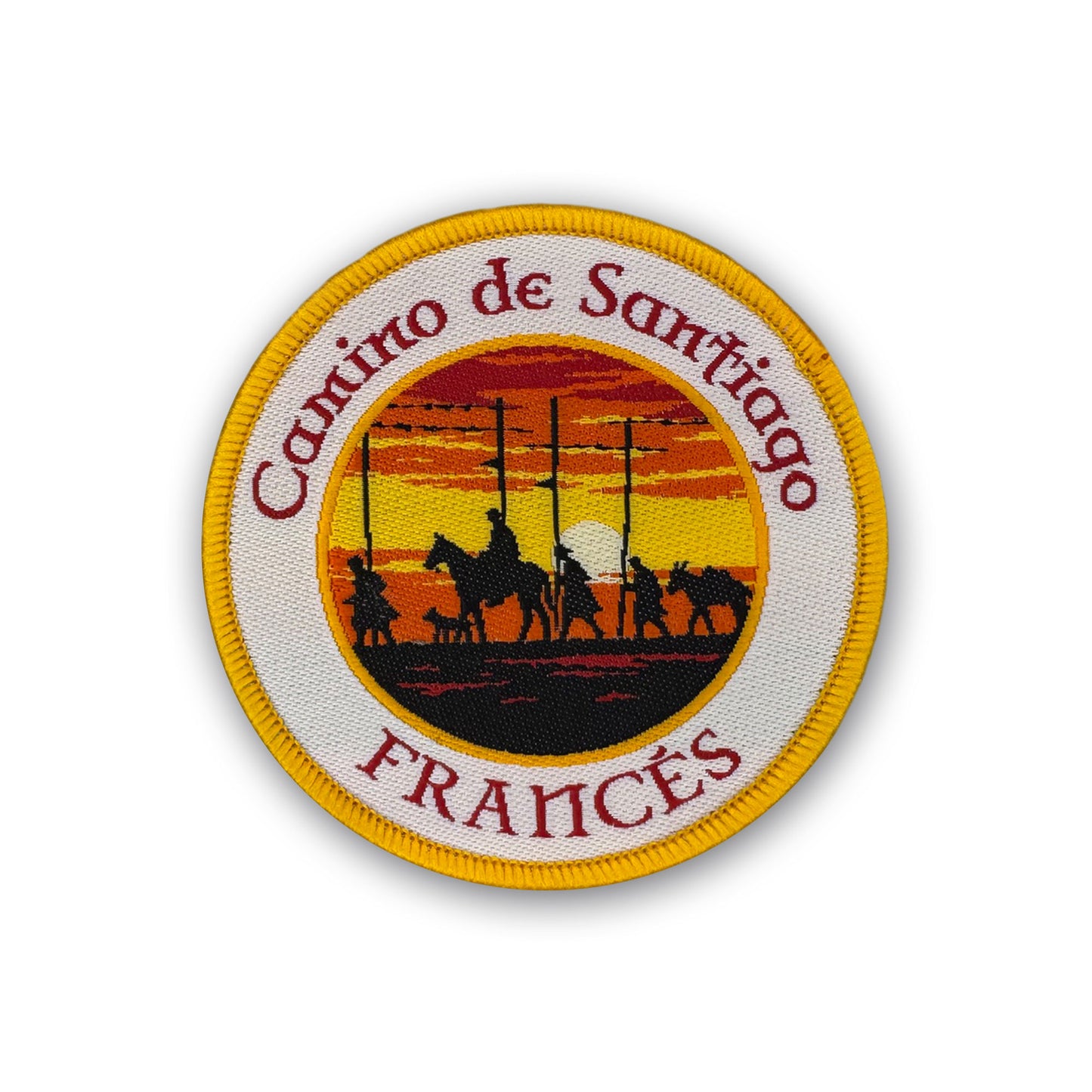 Round woven Camino de Santiago Francés patch featuring silhouetted pilgrims at Alto del Perdón at sunset with yellow merrowed border