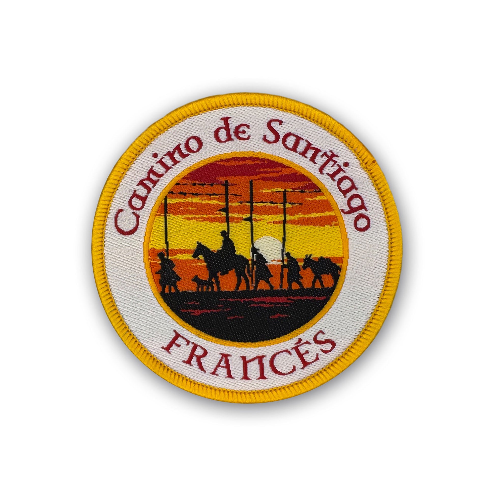 Round woven Camino de Santiago Francés patch featuring silhouetted pilgrims at Alto del Perdón at sunset with yellow merrowed border