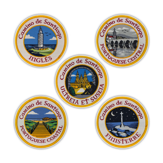 Five circular woven patches depicting different routes of the Camino de Santiago on a white background.
