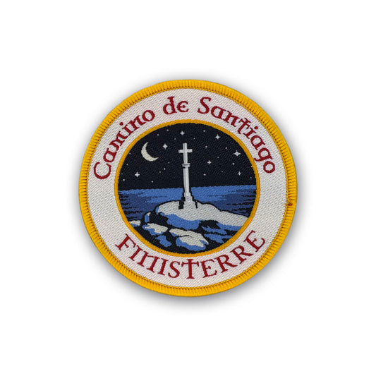Camino Finisterre patch showing Cruz de Finisterre under a starry sky on white background