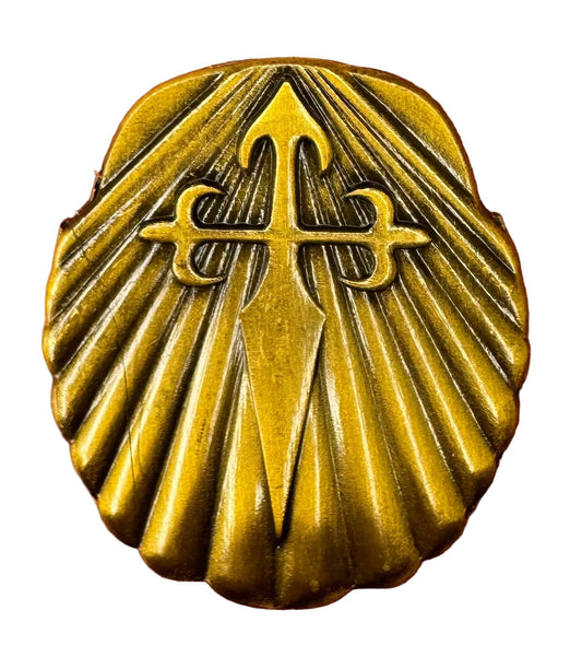 Brass Saint James medallion on a white background