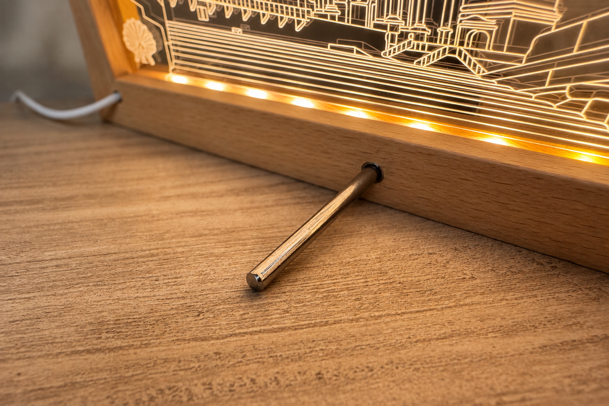 Close-up of the LED frame's rear kickstand and lit LED strip on a warm wood surface with a softly blurred background.