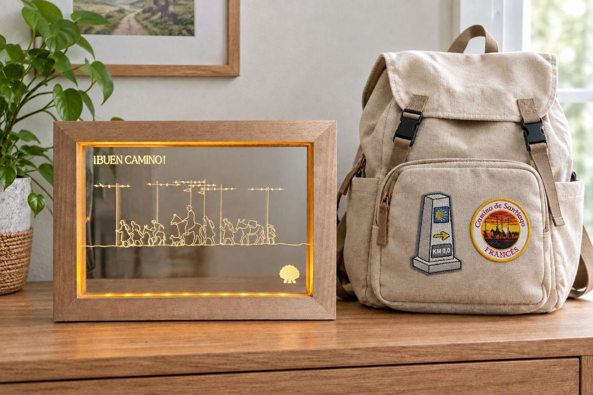 Pilgrim Artifact Camino de Santiago LED frame beside a rucksack decorated with two Camino de Santiago patches.